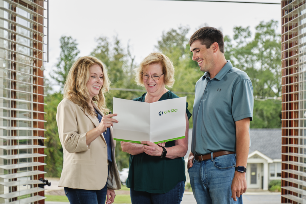 Three accountants looking at a folder